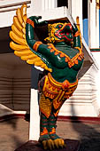 Vientiane, Laos - Pha That Luang, this statue of garuda is from the temple fronted by two tall standing Buddha statues. 